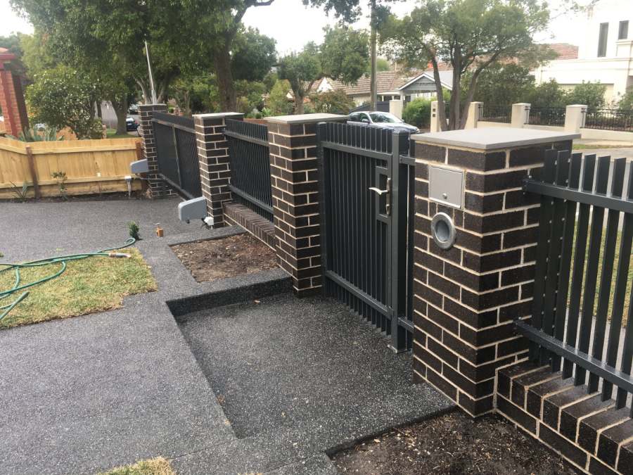 Dark brick gate piers with aluminium slats and intercom